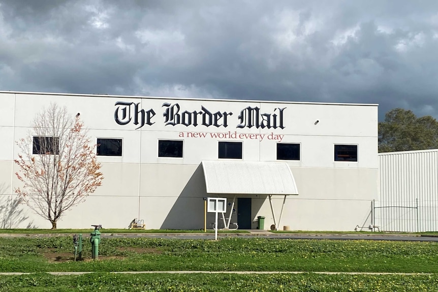 close up of Border Mail sign and building