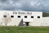 close up of Border Mail sign and building