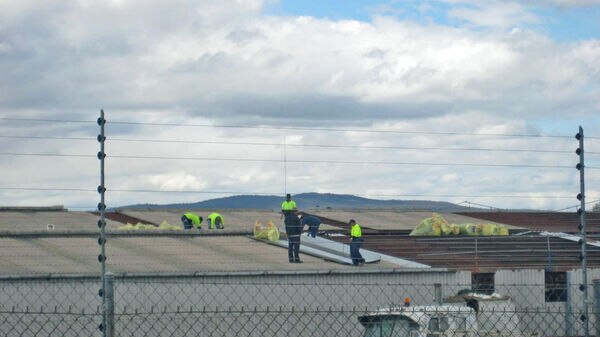 The CFMEU says it took this photo on Friday of worker removing sheeting from the roof of the Pickles building.