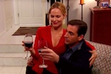 Still of Jan sitting on Michael's lap in The Office episode The Dinner Party
