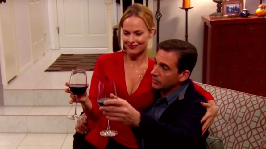 Still of Jan sitting on Michael's lap in The Office episode The Dinner Party