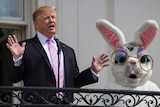 Donald Trump, joined by the Easter Bunny, speaks from the Truman Balcony of the White House in Washington.