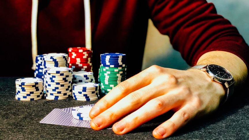 A generic picture of someone at a casino table with gambling chips.