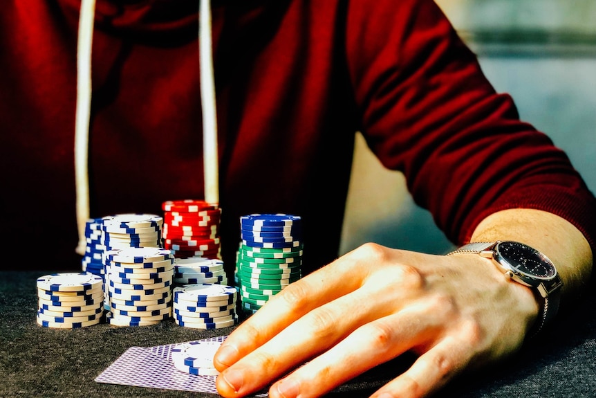 A generic picture of someone at a casino table with gambling chips.
