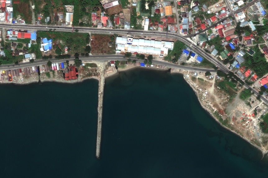 This August 17, 2018, satellite photo provided by DigitalGlobe shows a view of the a jetty in Palu, Indonesia.