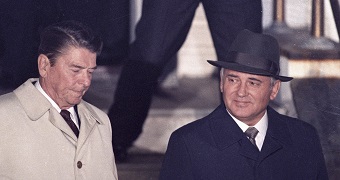 Ronald Reagan and Mikhail Gorbachev walk side by side.