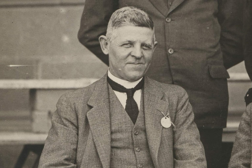 George Pritchard, pictured in the early 20th century, sits down, dressed in a suit.