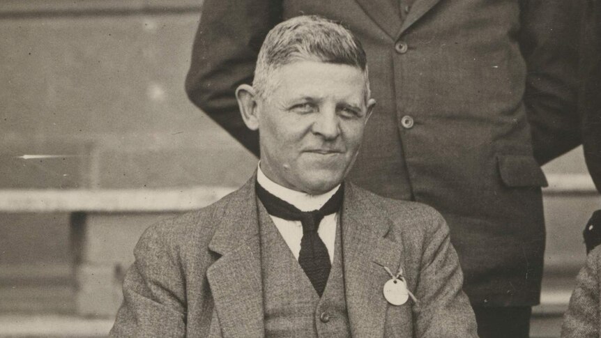 George Pritchard, pictured in the early 20th century, sits down, dressed in a suit.