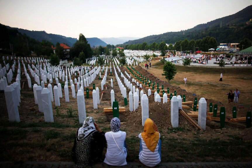 Bosnian women look over massacre graveyard