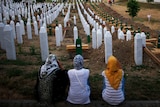 Bosnian women look over massacre graveyard