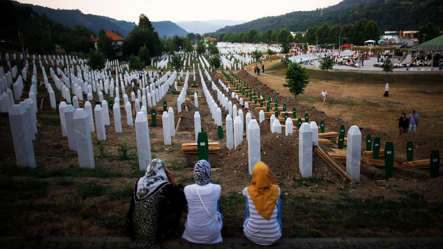 Bosnian women look over massacre graveyard