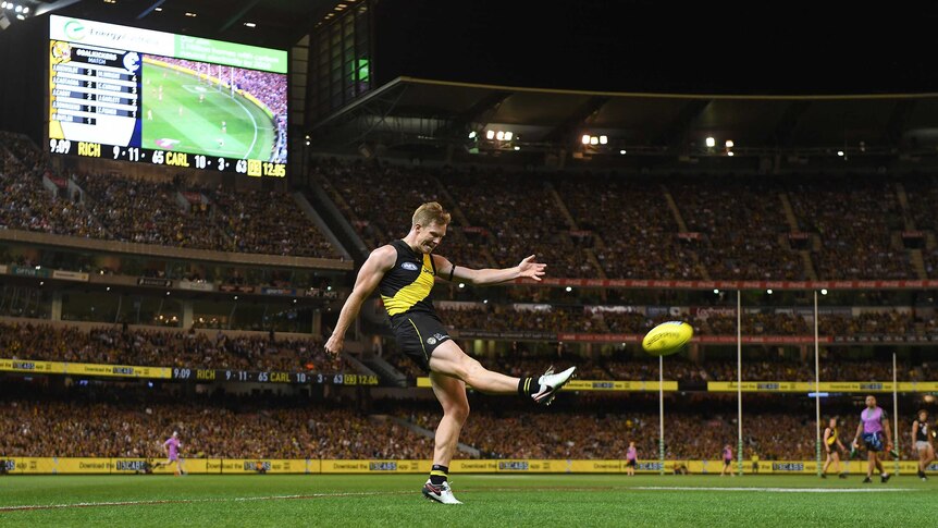 Jack Riewoldt of the Tigers kicks for goal against Carlton at the MCG.