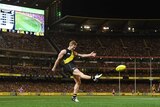 Jack Riewoldt of the Tigers kicks for goal against Carlton at the MCG.