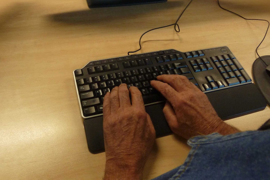 Man's hands on computer with screen blurry