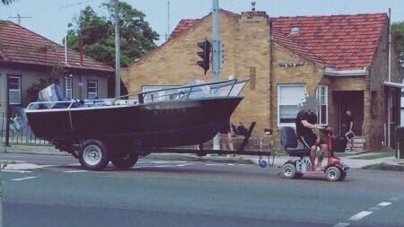 A keen fisherman who used a mobility  scooter to tow his boat has been charged by police.