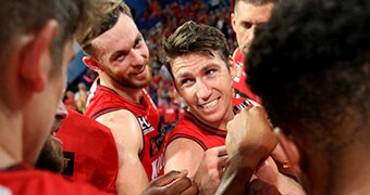 Perth Wildcats players in a team huddle.