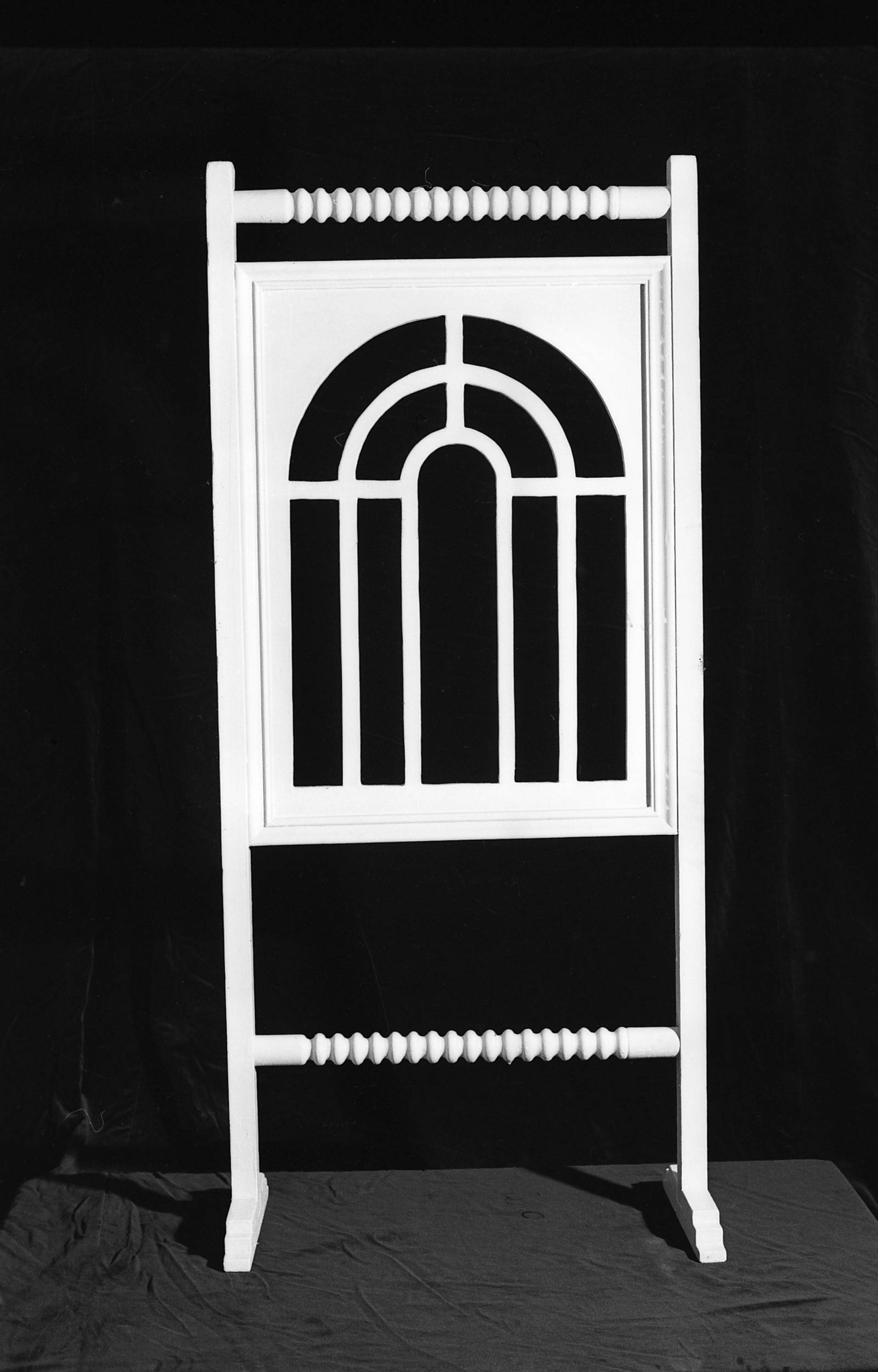 A white arched window displayed on a black background.