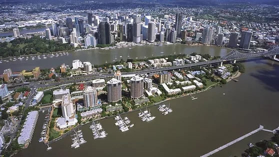 View of city skyline on river with marina and boats