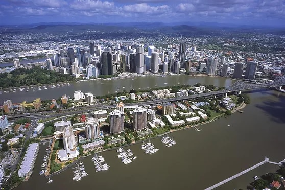 View of city skyline on river with marina and boats