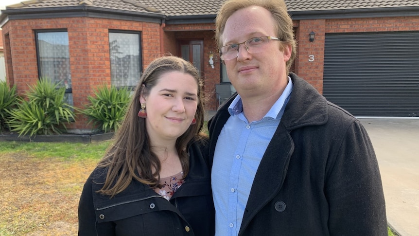 Lauren and Luke stand out the front of a brick home in Horsham.