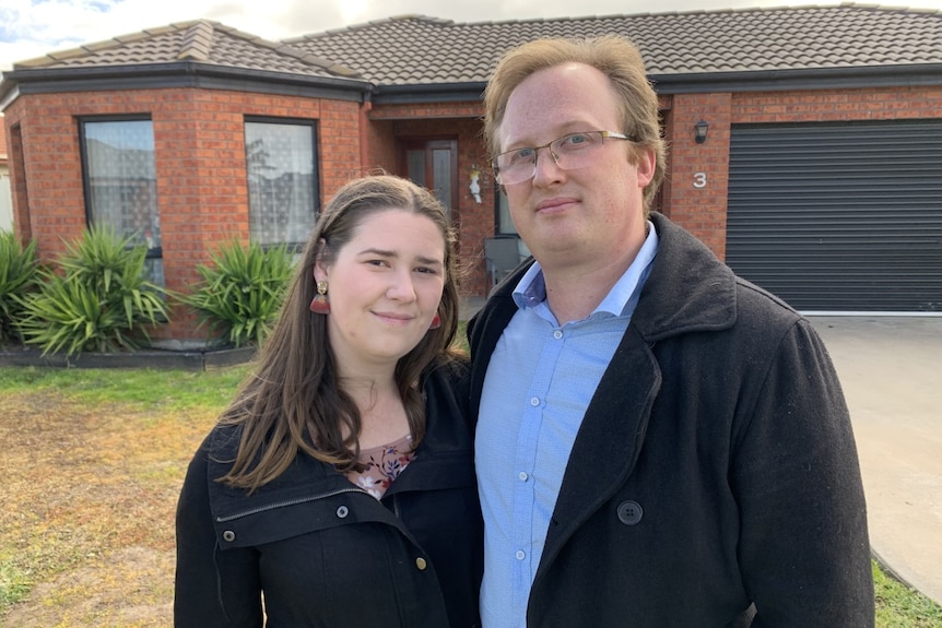 Lauren and Luke stand out the front of a brick home in Horsham.