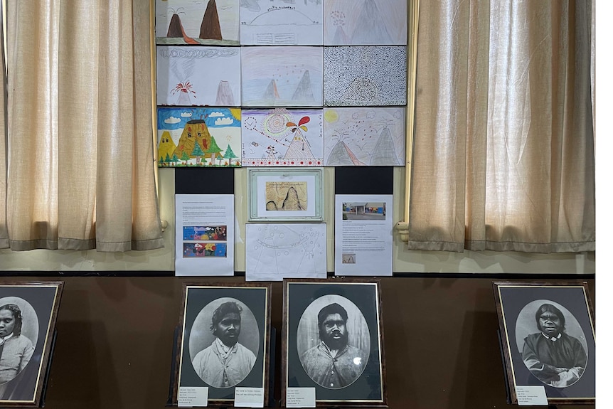 School children's drawings above historic photographs of Aboriginal people. 