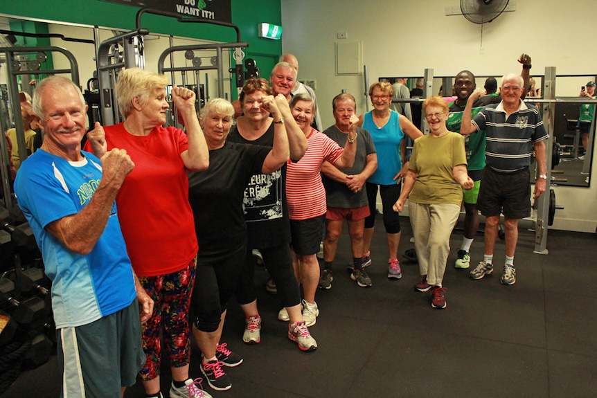 Group of seniors flexing their muscles and laughing