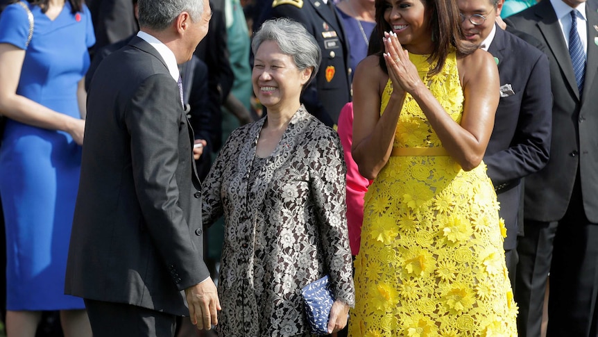 Ho Ching holding purse with Michelle Obama