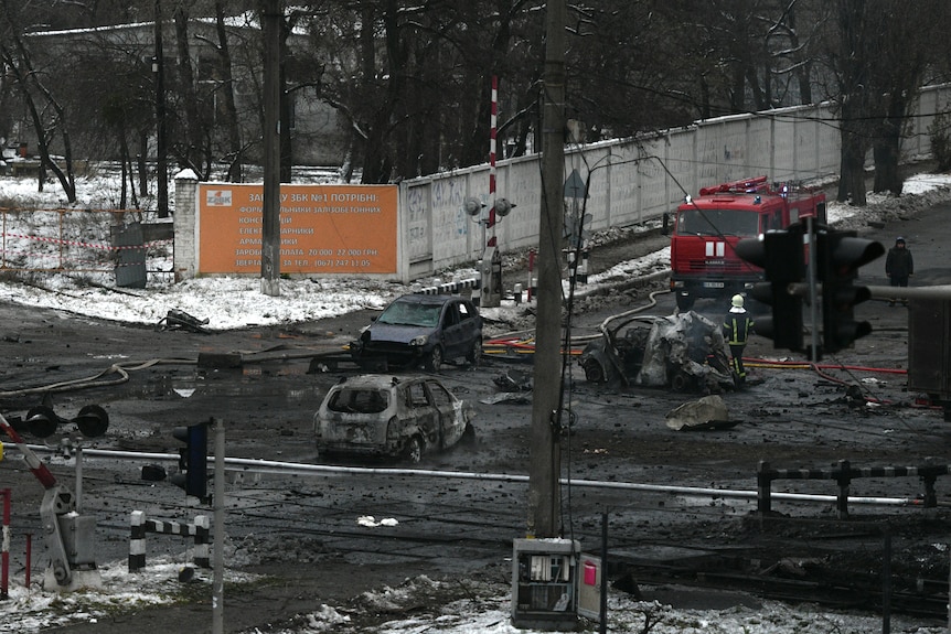 Damaged cars seen at the scene of Russian shelling on a Kyiv street.