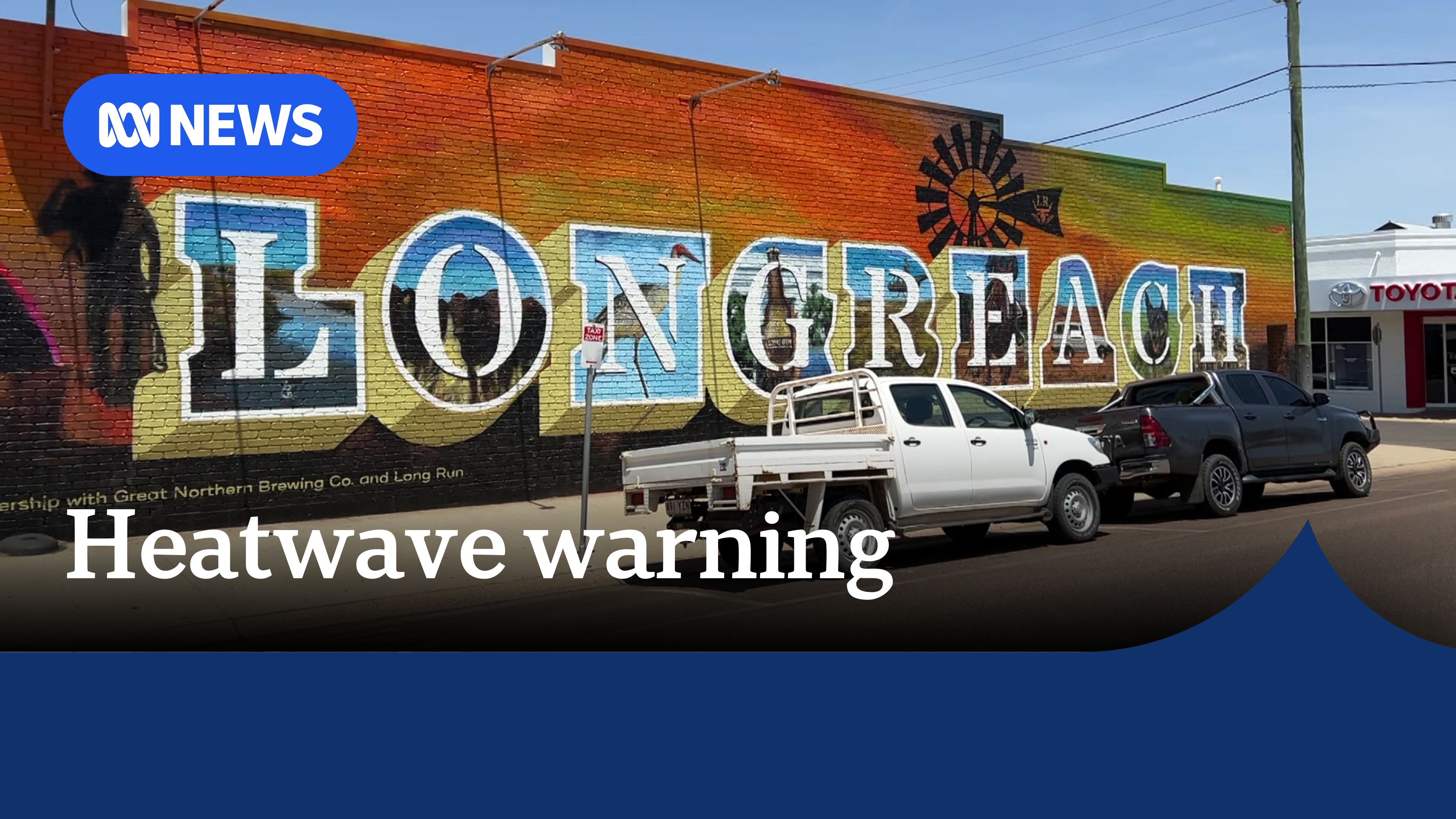 Heatwave warning: Mural of Longreach town name on brick wall. 