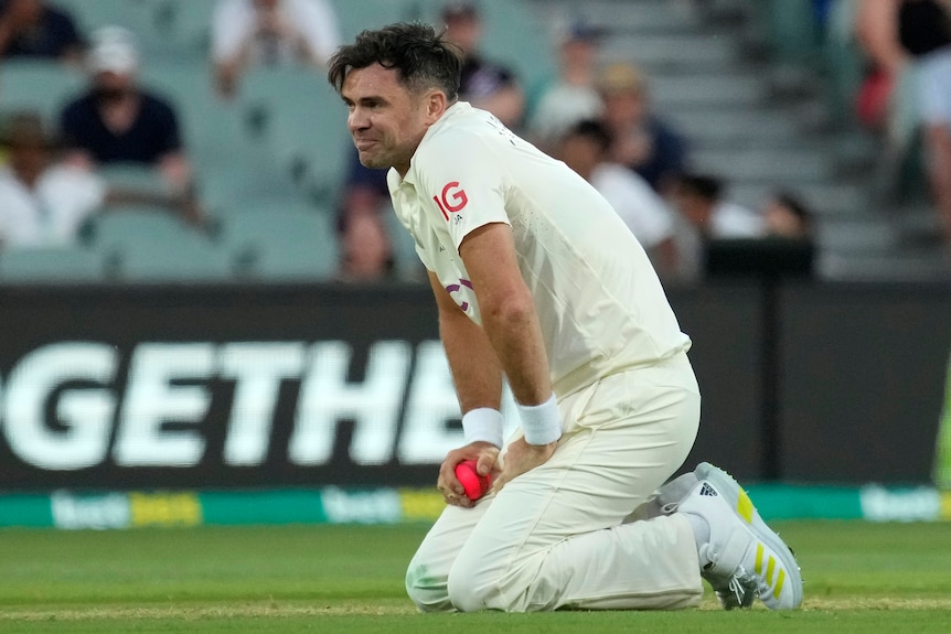 James Anderson on his knees with his hands on his thighs