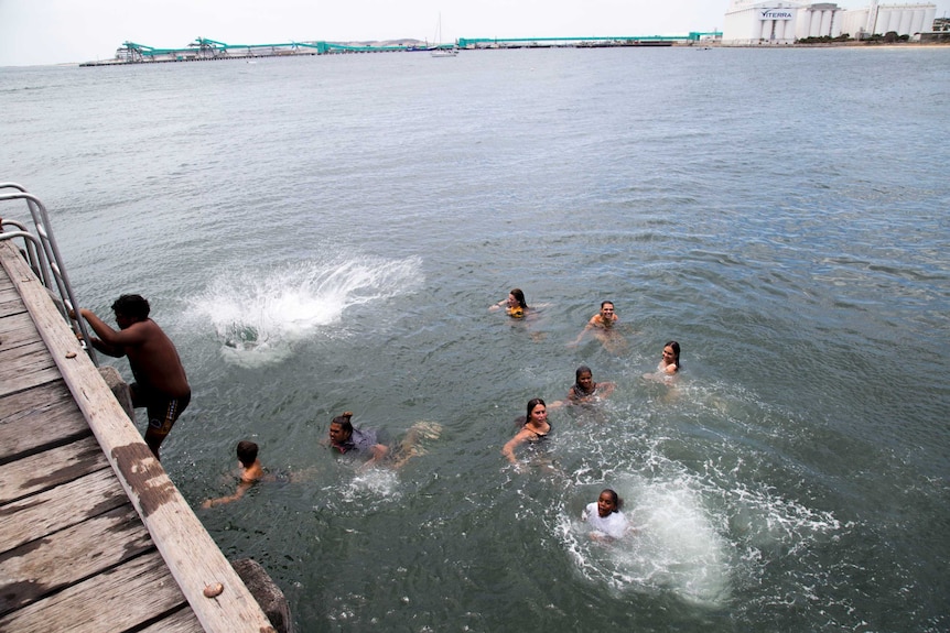 People cool off in the water off the Port Lincoln jetty.