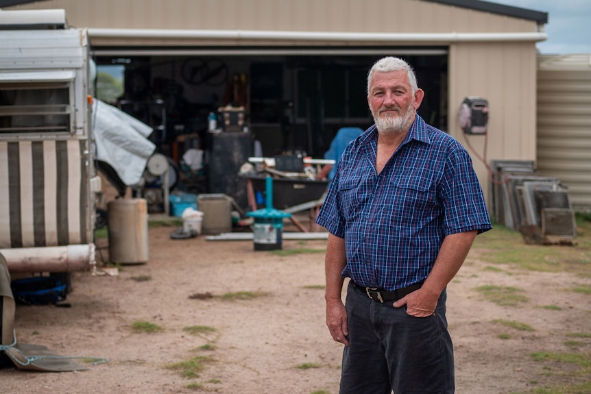 Allan Marshall stands outside his shed at his property at Grantham in southern Queensland.