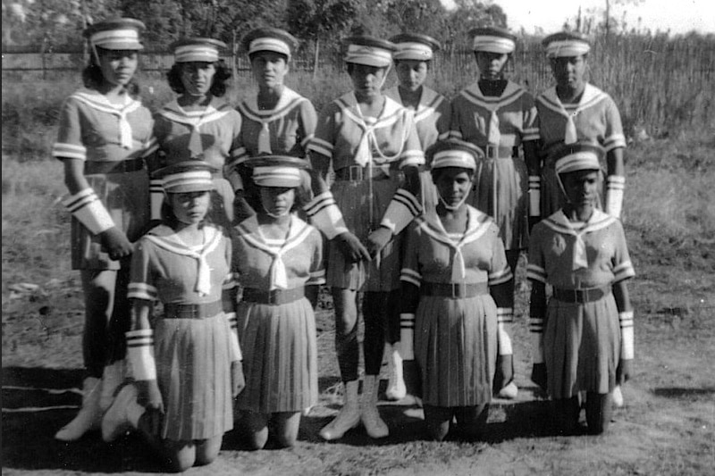 This 1961 black and white photo shows 11 young Aboriginal girls in their marching uniforms