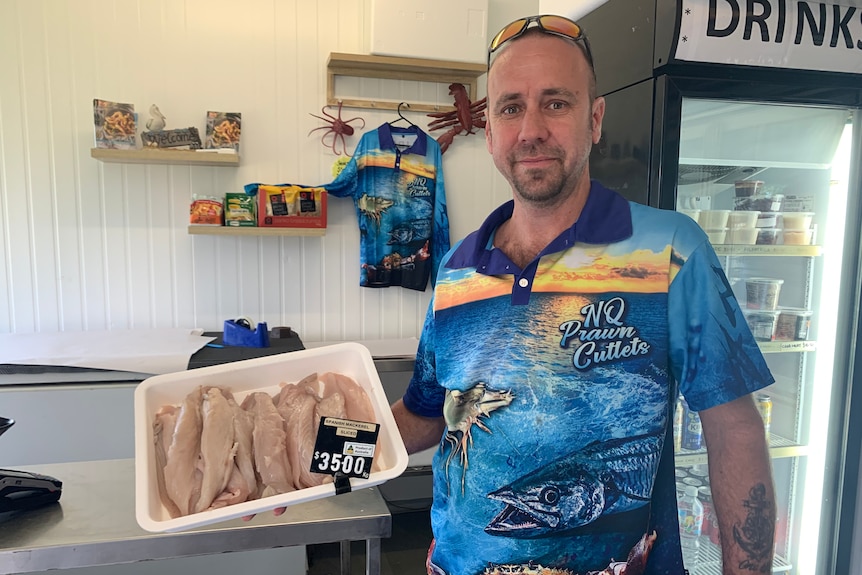 man holding fish fillets