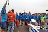 Dutch team celebrations as Nuna7 finishes the World Solar Challenge under grey skies in northern Adelaide.