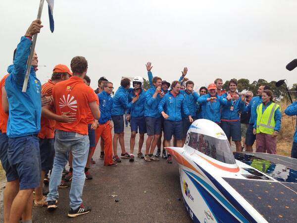 Dutch team celebrations as Nuna7 finishes the World Solar Challenge under grey skies in northern Adelaide.