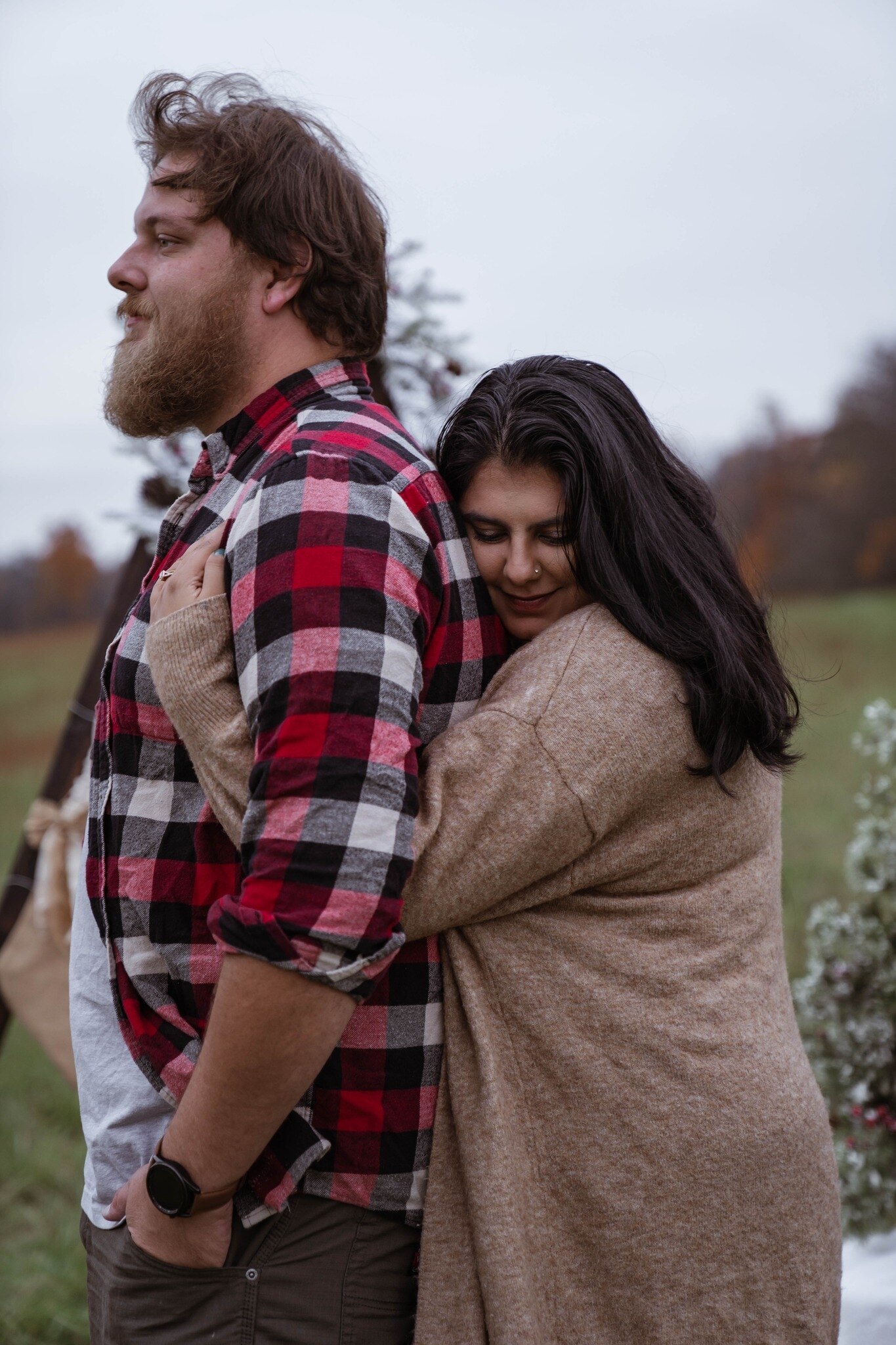 A woman hugging a man from behind 