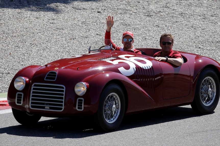 Sebastian Vettel greeted fans from a vintage Ferrari ahead of the race.