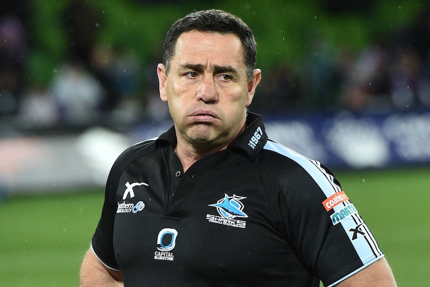 A man looks glum after losing a rugby league match