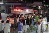 Rescue workers unload earthquake victims from an ambulance in Pakistan.
