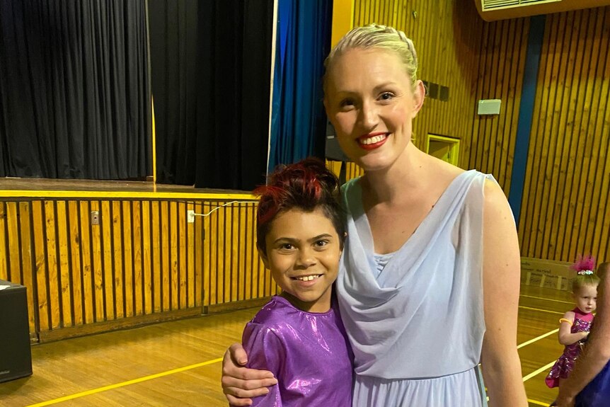 A young male dancer standing with his dance teacher.