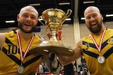 Australian Steelers Chris Bond and Ryley Batt with the trophy after winning the wheelchair rugby world championship final.