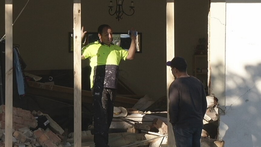 Assessor talks to the home owner about the damage to the property