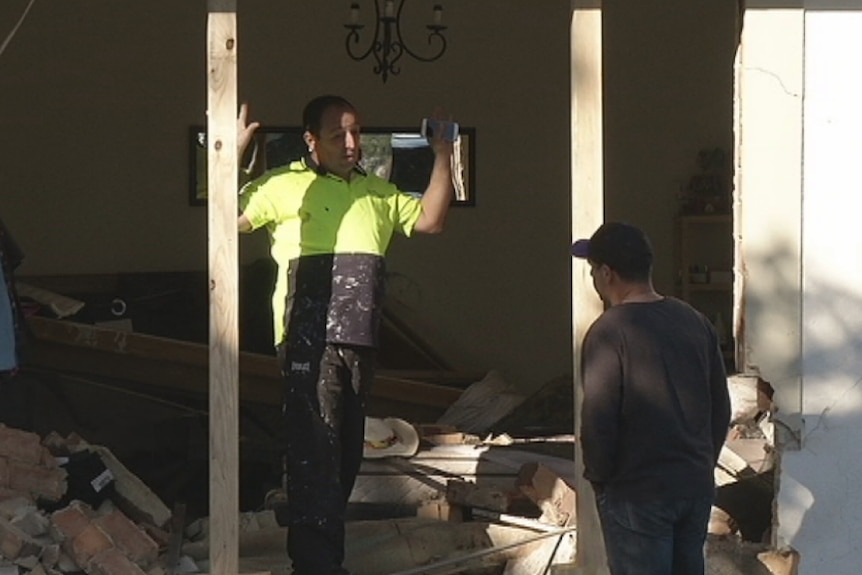 Assessor talks to the home owner about the damage to the property