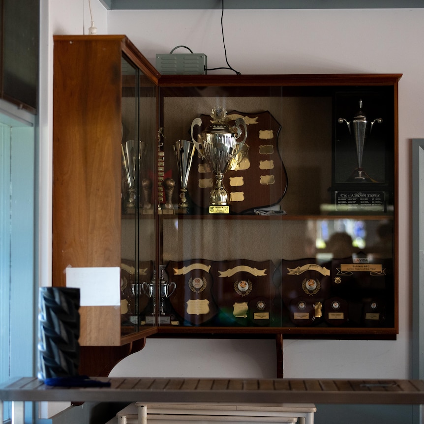 A wide shot of a trophy cabinet on a wall inside Subiaco AFC's clubrooms.