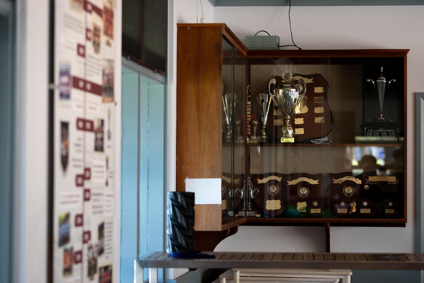 A wide shot of a trophy cabinet on a wall inside Subiaco AFC's clubrooms.