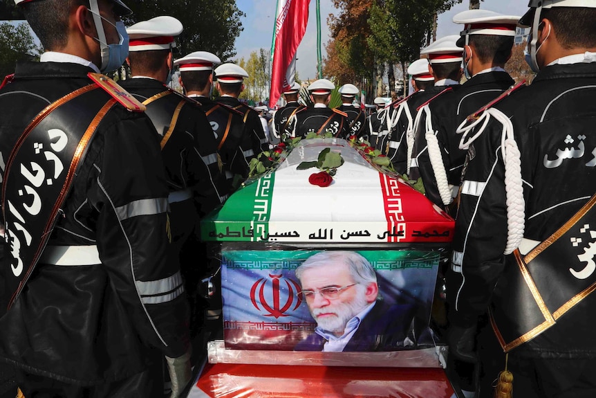 Military personnel stand near the flag-draped coffin of Mohsen Fakhrizadeh