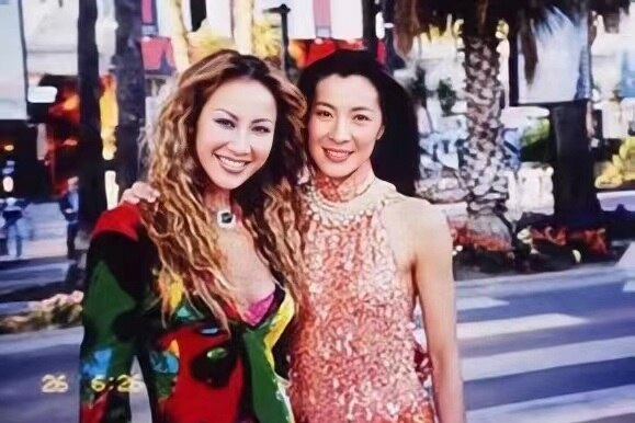 Young CoCo Lee and Michelle Yeoh pictured together in street.