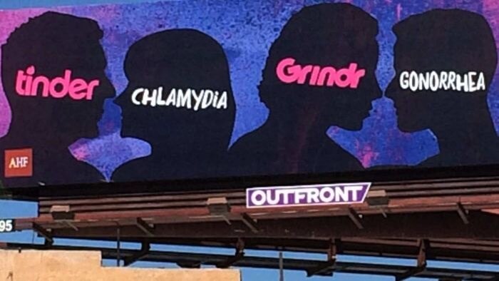 A close up photo of a billboard saying Tinder, Grindr and STI's are connected.